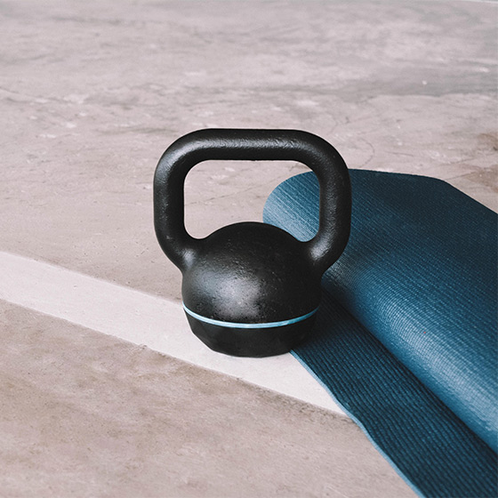 kettlebell and yoga mat on gym floor